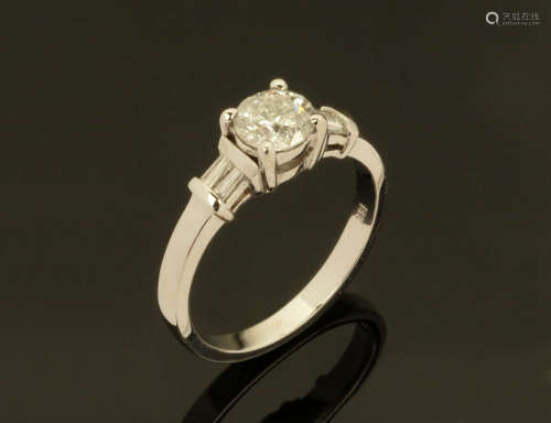An 18 ct white gold ring, set with a central diamond with ba...