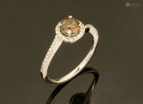 An 18 ct white gold ring, set with a natural intense fancy b...