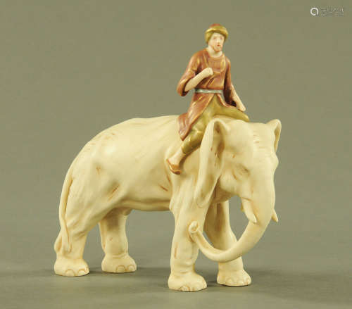 A Royal Dux style elephant with rider. Height 23 cm.