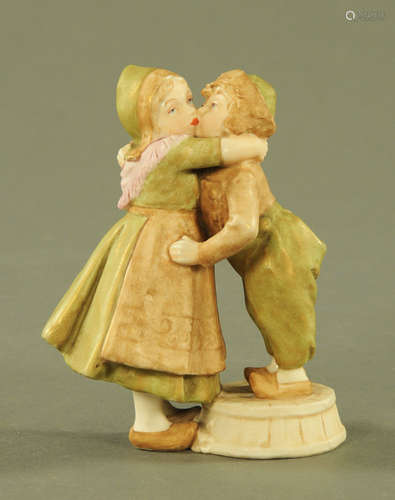 A Royal Dux figure group Dutch children kissing, pink triang...