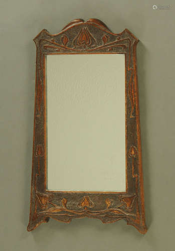 An oak framed rectangular mirror in the Arts & Crafts style....