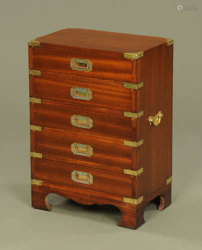 A military style mahogany bedside chest, five drawers with r...