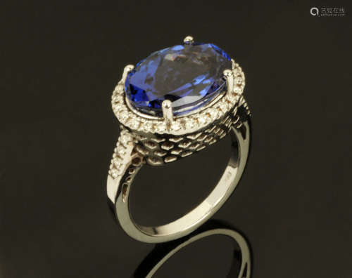 An 18 ct white gold ring, set with an oval cut tanzanite and...