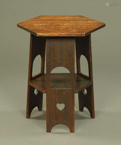 An oak Arts and Crafts hexagonal occasional table with angle...