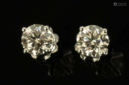 A pair of 18 ct gold stud diamond earrings, diamond weight +...
