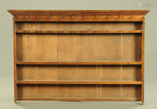 A Georgian oak Delft rack, with panelled back and open shelv...