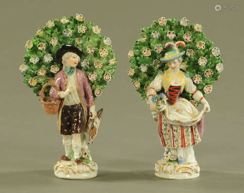 A pair of Continental porcelain, lady and gentleman with boc...