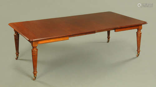 A Victorian mahogany wind out dining table with two leaves,