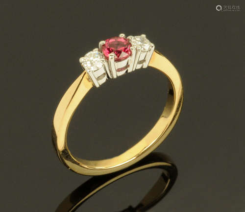 An 18 ct yellow gold ruby and diamond three stone ring, ruby...