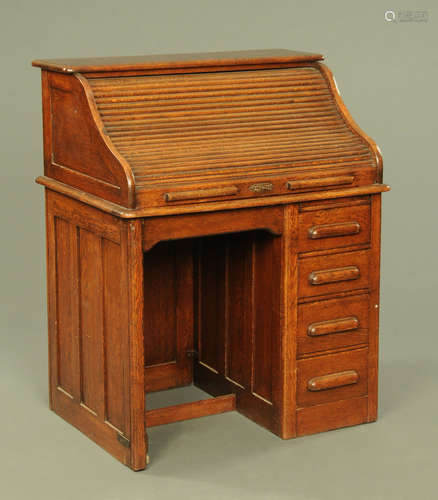 A small oak roll top desk, with fitted interior and with dra...