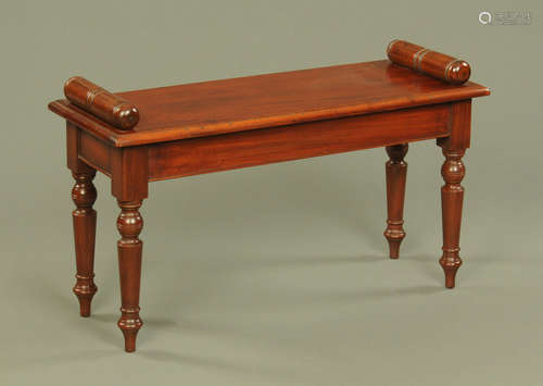 A mahogany window seat, with bolster ends and raised on turn...