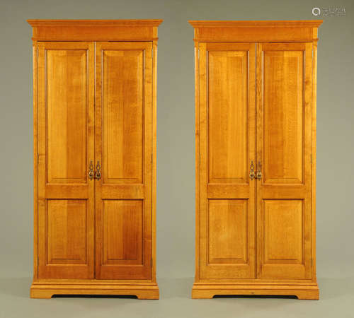 A pair of oak wardrobes,