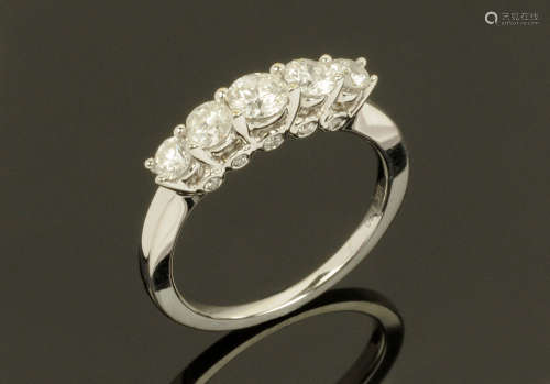 An 18 ct gold five stone diamond ring, Size N/O. Diamond wei...