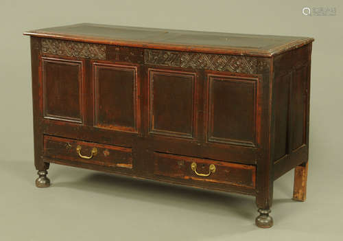 An early 18th century four panelled oak mule chest,