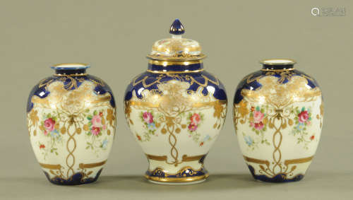 A garniture of three Noritake vases, painted with floral spr...