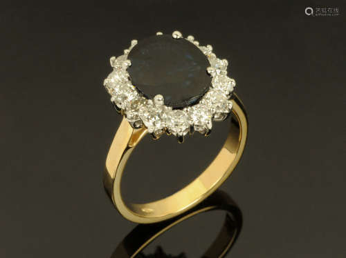 An 18 ct gold sapphire and diamond cluster ring, sapphire +/...