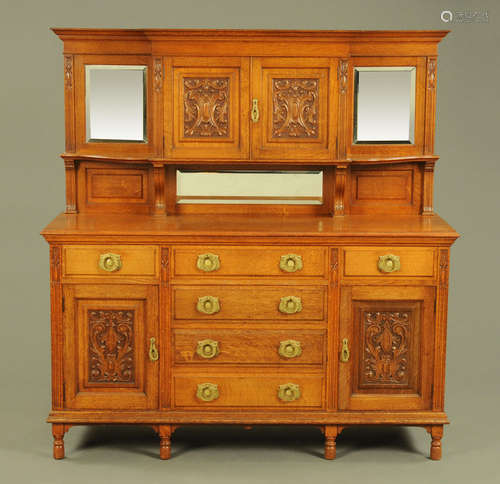 A late Victorian Arts and Crafts oak sideboard, in two secti...