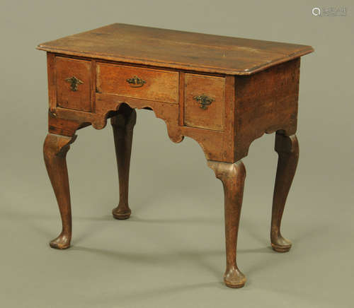 A George III oak lowboy, with rounded corners,