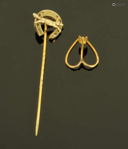 An Edwardian gold coloured metal stick pin, surmounted by a ...