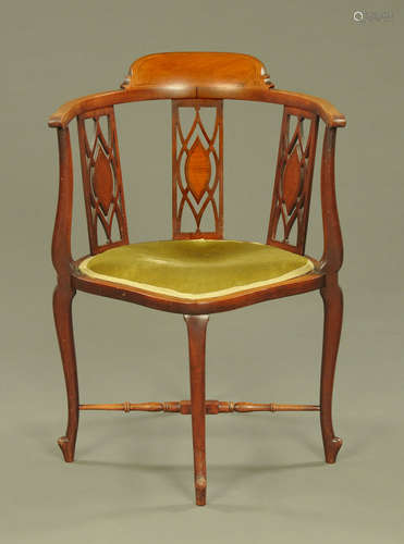 An Edwardian inlaid mahogany corner armchair, with three spl...