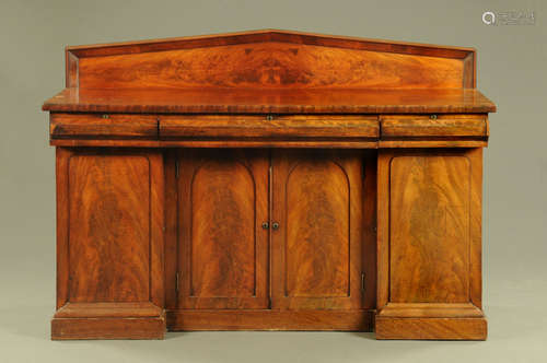 A Victorian mahogany sideboard, with rear triangular upstand...