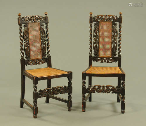 A pair of oak hall chairs, with carved top rails,