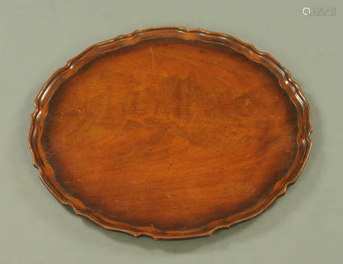 A George III style mahogany tray with piecrust edge, diamete...