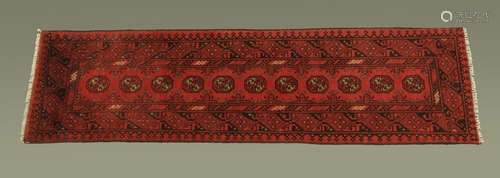 A Turkish woollen runner, principal colours red and black. 6...