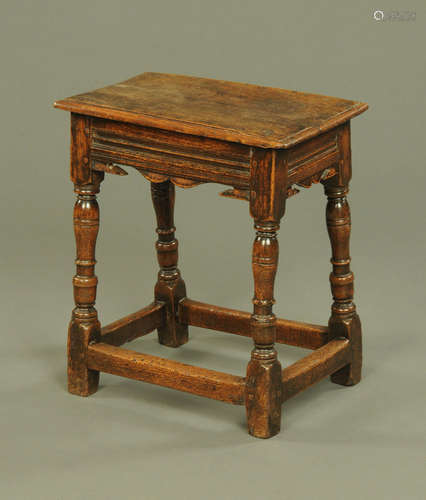 An 18th century oak joint stool, with moulded edge,