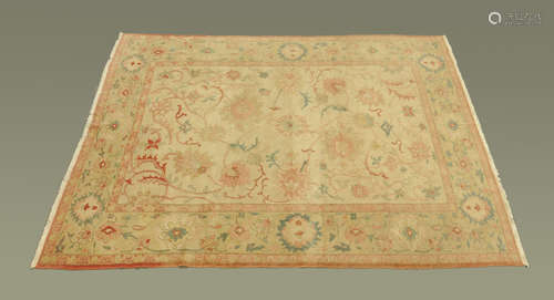 A Turkish woollen rug, principal colours beige, pink and yel...