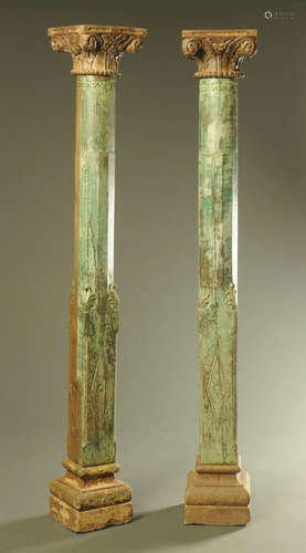 A pair of antique teak columns, with carved capitals,