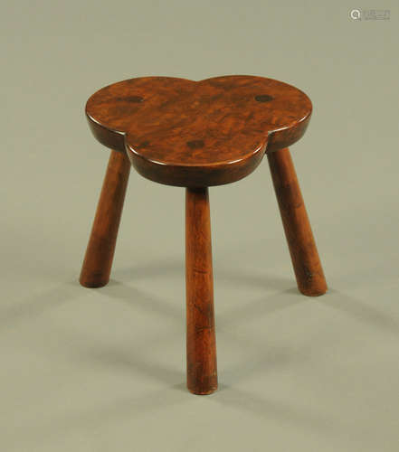 A yew wood trefoil stool, well figured with three angled sup...