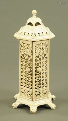 A white painted cast iron greenhouse heater, hexagonal raise...