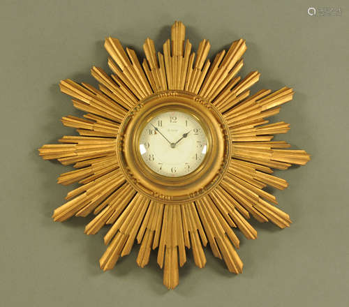 A giltwood framed Sunburst eight day wall clock, with French...