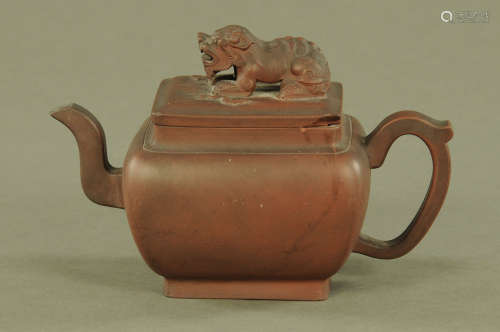 A Chinese Yixing teapot, with dog terminal. Height 14 cm, le...