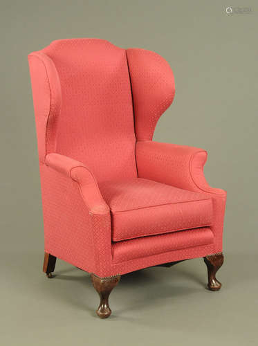 A mahogany wing easy chair, in the Queen Anne style,