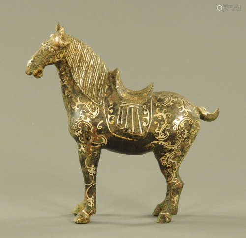 A Chinese bronze figure of a standing horse, with silver col...