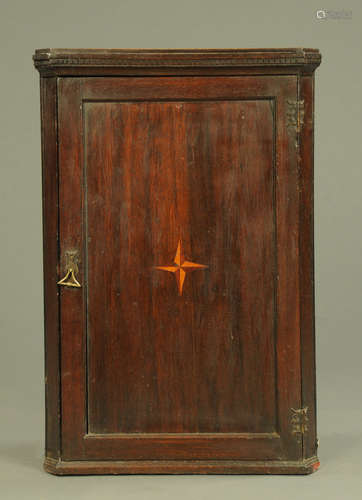 A George III oak hanging corner cupboard,