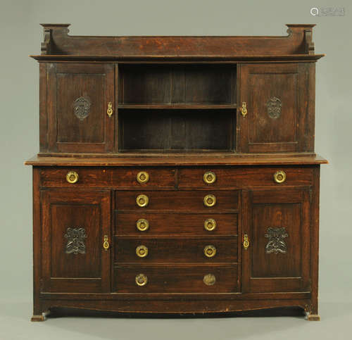 A late 19th/early 20th century Arts & Crafts oak sideboard,