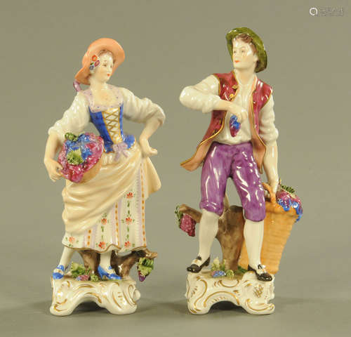 A pair of continental porcelain figures of grape harvesters....