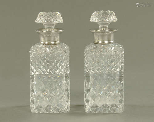 A pair of silver mounted cut glass square form decanters, ea...