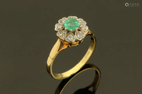 An 18 ct gold diamond cluster ring, with centre green stone,...