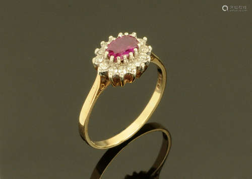 A 9 ct gold cluster ring with ruby coloured centre stone, an...