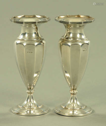 A pair of silver vases, with octagonal top and circular foot...