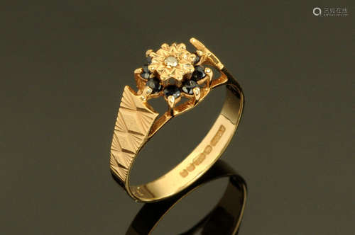 A 9 ct gold diamond and sapphire cluster ring, Size K.