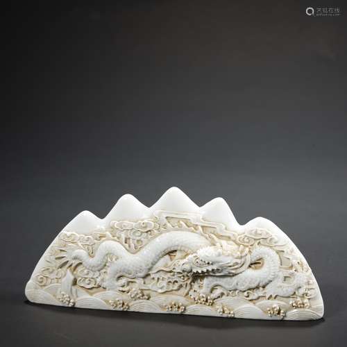 A CHINESE WHITE-GLAZED CARVED 