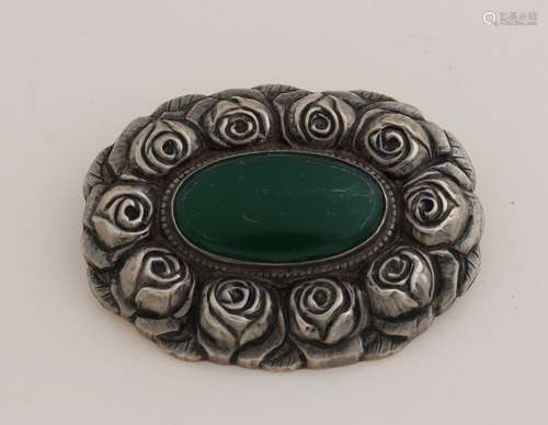 Silver brooch with green stone