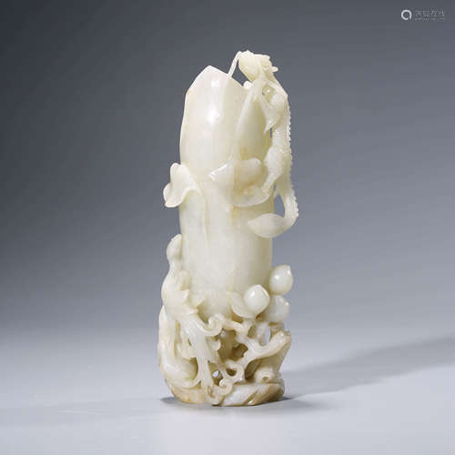 A CHINESE WHITE JADE BEAST AND PEACHES ORNAMENT