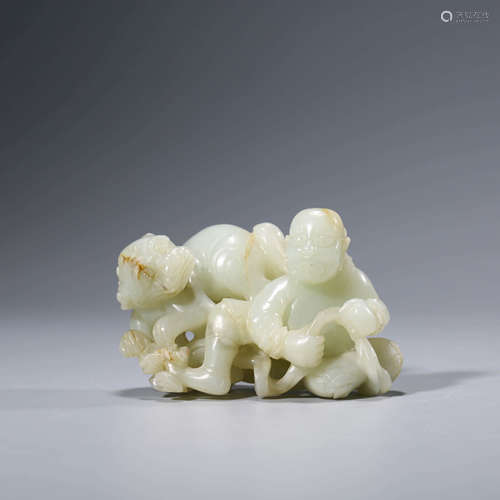 A CHINESE WHITE JADE CHILD AND BEAST ORNAMENT