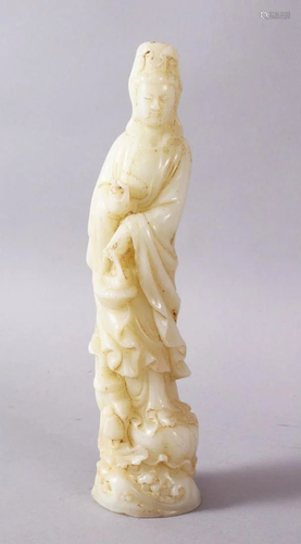 A CHINESE CARVED WHITE JADE FIGURE OF GUANYIN, stood